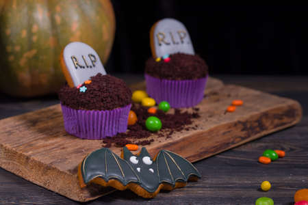 Halloween party and decoration conceptt. Halloween cupcakes and colored sweetsの写真素材