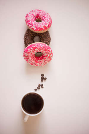 Tasty and delicious donuts with different icing and filling on a colored background with...