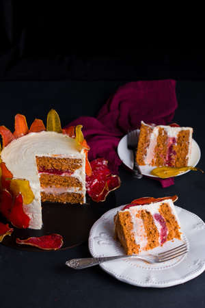 Beautiful and delicious dessert. The cake on the stand is decorated with red and yellow pears on the...