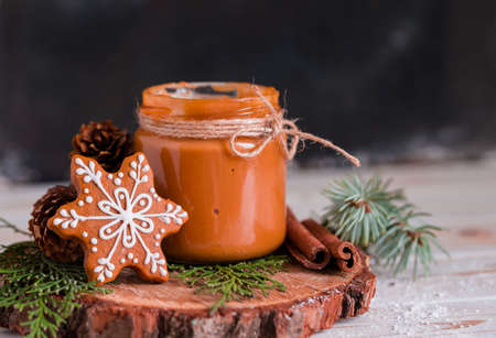 Christmas cookies with homemade salted caramel on a wooden background, neon lights, cinnamon sticks. New years 2020の写真素材