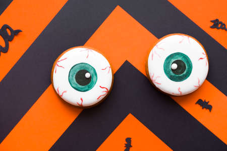 Halloween conten parties and decorations. Black-orange background and gingerbread cookies.の写真素材
