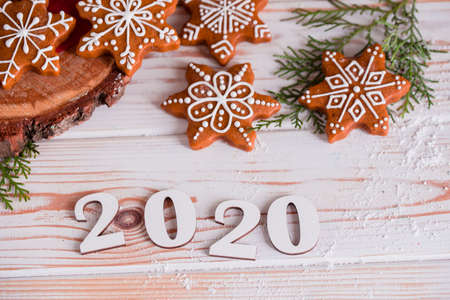 Christmas cookies with homemade salted caramel on a wooden background, neon lights, cinnamon sticks. New years 2020の写真素材