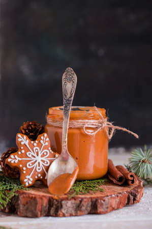 Christmas cookies with homemade salted caramel on a wooden background, neon lights, cinnamon sticks. New years 2020の写真素材