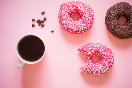Tasty and delicious donuts with different icing and filling on a colored background with coffee.Donuts on link backgroundの写真素材