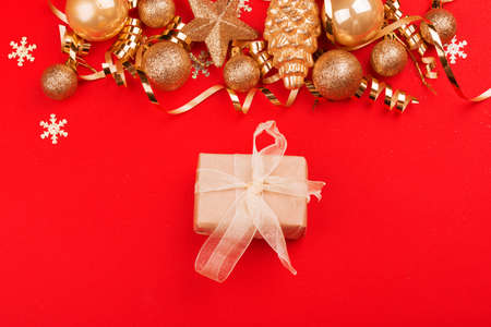 Beautiful festive red background with sparkles and Christmas golden toys. Holiday Content. New year...