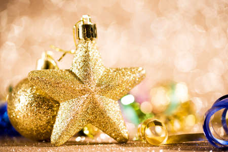 Festive content on a glittery background of gold color with serpentine, toys, sparkles. Flat layの写真素材