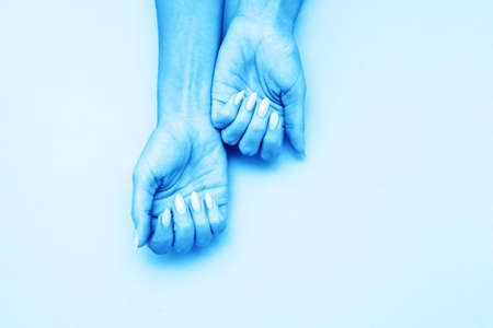 Stylish trendy female manicure. Beautiful young woman's hands on soft blue background.
