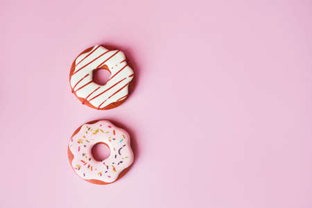 Fragrant gingerbread in the form of doughnuts on a pink background. Flat lay