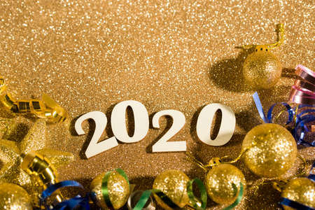 Festive content on a glittery background of gold color with serpentine, toys, sparkles. Flat layの写真素材
