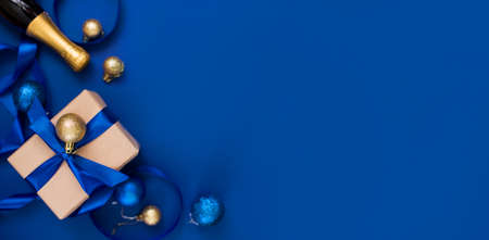 New Year's gift on a blue background, with a beautiful satin ribbon. Christmas. New Year's content....