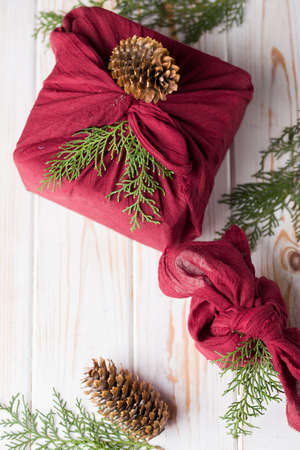 Christmas furoshiki wrapping. Etnical hristmas gift. Zero waste concept 2020