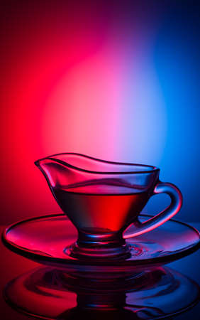 One glass cup with a pattern, with fragrant tea on a red background, concept of cups.の写真素材