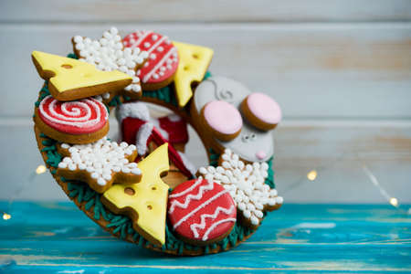 Beautiful and delicious gingerbread with pieces of cheese, mouse, balls for the Christmas tree. New years 2020の写真素材