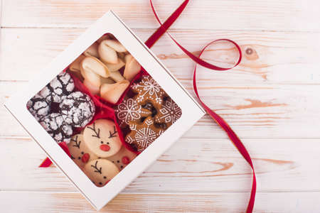 Beautiful tasty homemade cookie in the form of a muzzle of a deer on a wooden tray. Christmas foodの写真素材