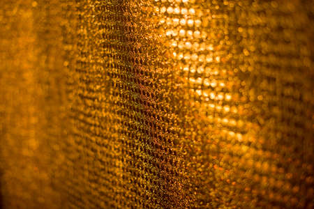 Beautiful textured fabric of gold color. Art content. Golden background. Holidays contentの写真素材