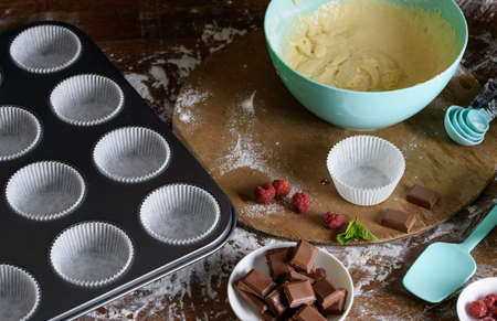 The process of baking delicious muffins with berries, white cream, chocolate. Beautiful decoration...