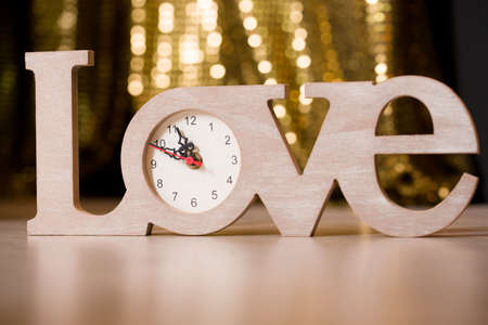 Content for Valentine's Day. Clock in the form of the word love. Holiday of loveの写真素材