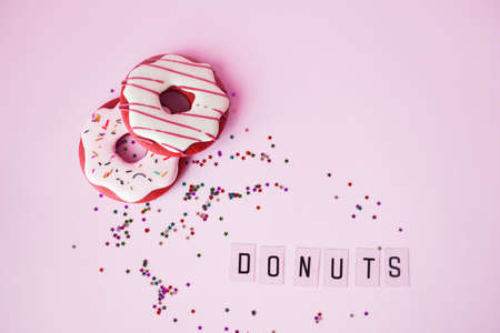 Big donut and Gingerbread donut on pink background birthday decoration. Party