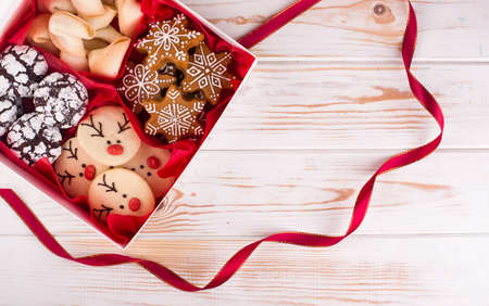 Beautiful tasty homemade cookie in the form of a muzzle of a deer on a wooden tray. Christmas foodの写真素材