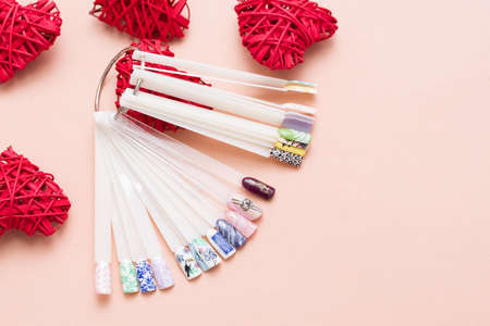 Beautiful stylish female manicure on a pink background with valentines decor. Happy valentines dayの写真素材