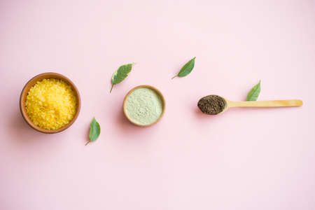 Cosmetic bath salt, grape gomaj for the face, coffee scrub for the body on a pink background. Caring for the face and body.の写真素材