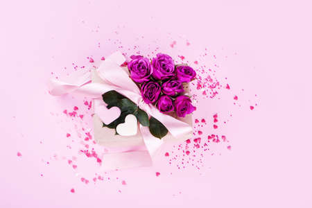 Beautiful box with satin ribbon, with small hearts, chocolate hearts of milk chocolate. Valentine's Day.の写真素材