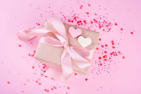Beautiful box with satin ribbon, with small hearts, chocolate hearts of milk chocolate. Valentine's Day.の写真素材