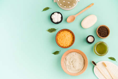 Caring for the face and body.Cosmetic bath salt, grape gomaj for the face, coffee scrub for the body on a mint background. Spa cosmetic, zero waste.の写真素材