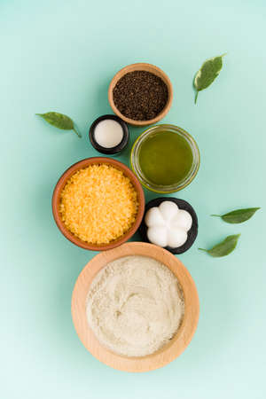 Cosmetic bath salt, grape gomaj for the face, coffee scrub for the body on a mint background. Spa cosmetic, zero waste. Organic cosmetic, eco.の写真素材