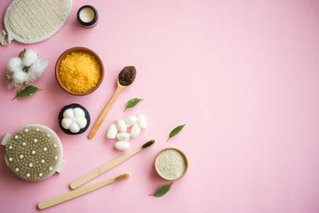Cosmetic bath salt, grape gomaj for the face, coffee scrub for the body on a pink background.の写真素材