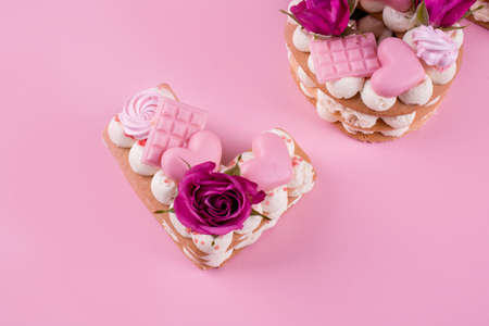 Dessert of cream, filling of cherries, cake of letters love, decorated with chocolate, merindos, natural flowers.の写真素材