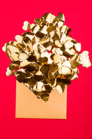 Bright red background with golden hearts, festive container, holiday of all lovers. Place for the...