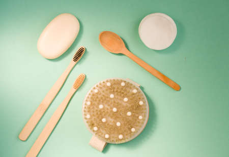 Cosmetic bath salt, grape gomaj for the face, coffee scrub for the body on a mint background. Spa...