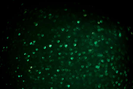 Color Bokeh on a dark background with hearts for use in graphic design. Abstract content. Valentines...