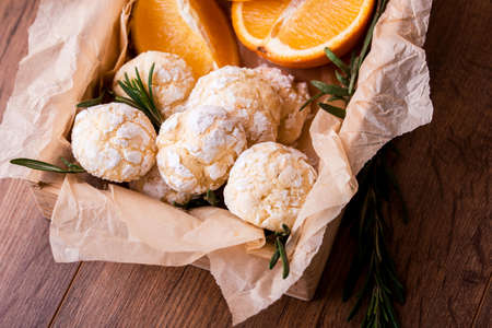 Shortbread orange biscuits with sprigs of semarin, with fresh orange and juice on the table. Delicious dessertの写真素材