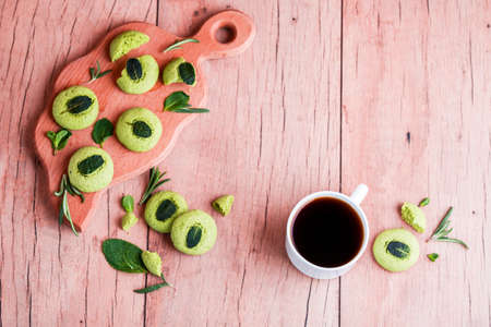 Shortbread cookies with mint, fragrant mint and sprigs of demen sedated on a wooden background. Tasty foodの写真素材