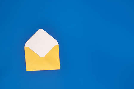 Yellow envelope for letters on a blue background.の写真素材