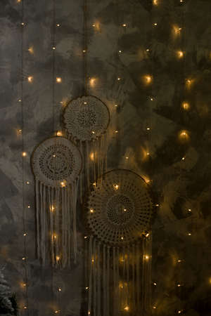 Beautiful dream catcher on the wall with lights. Boho handmade. Style