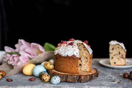 Easter composition with sweet bread, kulich and eggs on light background. Easter holidays breakfast...