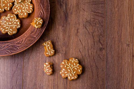 Ginger fragrant cookies in the form of flowers. Delicious cookies with orange juice on a wooden...