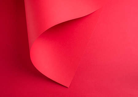 A beautiful abstract picture with two sheets of red paper. A place for text. View from aboveの写真素材