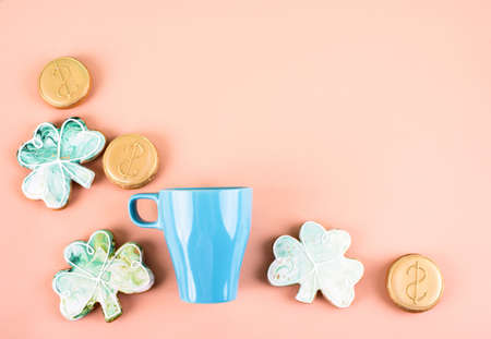 March 17 is St. Patrick's Day. Composition of sweet gingerbread and blue cup on a light background. A place for text.の写真素材