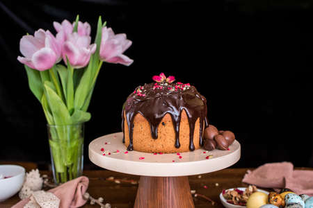 Easter composition with sweet bread, kulich and eggs on light background. Easter holidays breakfast...