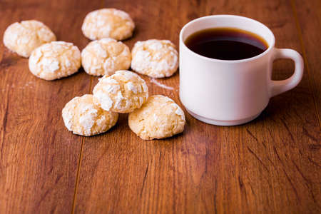 Shortbread orange biscuits with sprigs of semarin, with fresh orange and juice on the table....