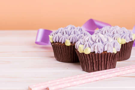 Chocolate cupcakes on a wooden table with salted caramel inside. Dessert