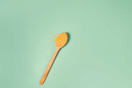 Cosmetic bath salt, grape gomaj for the face, coffee scrub for the body on a mint background. Spa cosmetic, zero waste. Organic cosmetic, eco.の写真素材