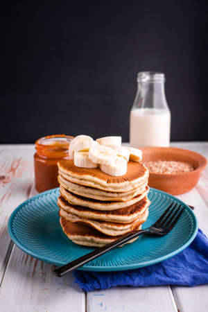 Delicious and lush pancakes with fresh fruits and berries, poured with salted caramel. Tasty breakfastの写真素材