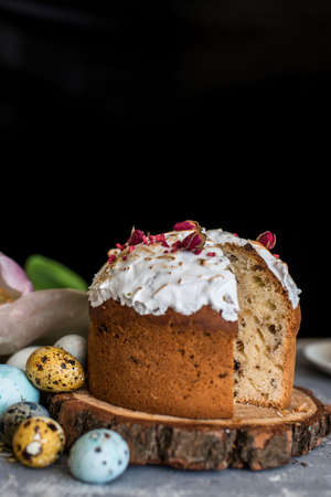 Easter composition with sweet bread, kulich and eggs on light background. Easter holidays breakfast...