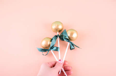 Delicious and beautiful cake pops on an abstract background. Delicious dessert for St. Patrick's Day