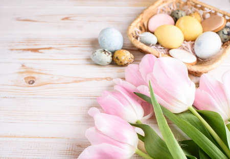 Beautiful Easter composition of eggs with natural colors, gingerbread, flowers, feathers. Holiday content.の写真素材